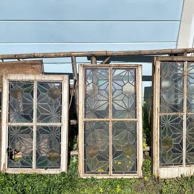 Antique leaded, stained glass windows, one needs repair.