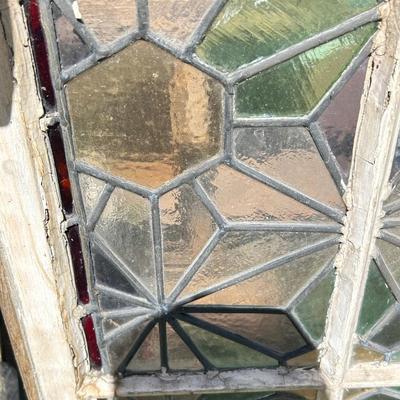 Antique leaded, stained glass windows, one needs repair.