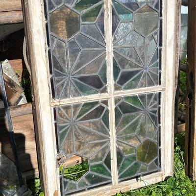 Antique leaded, stained glass windows, one needs repair.