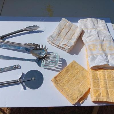 Stainless metal kitchen utensils with dish towels