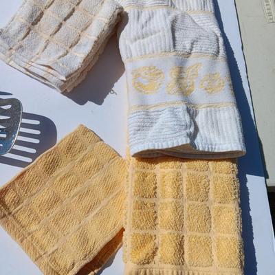 Stainless metal kitchen utensils with dish towels