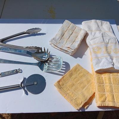 Stainless metal kitchen utensils with dish towels