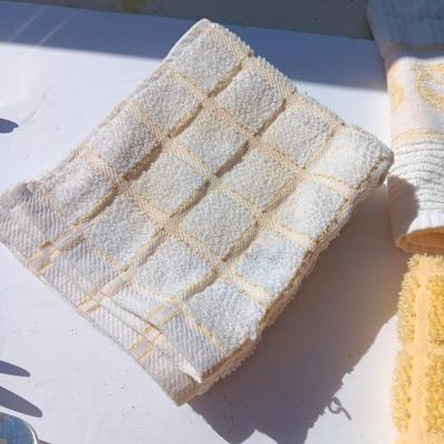 Stainless metal kitchen utensils with dish towels