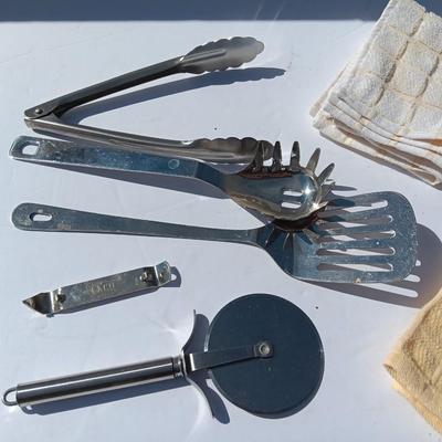 Stainless metal kitchen utensils with dish towels