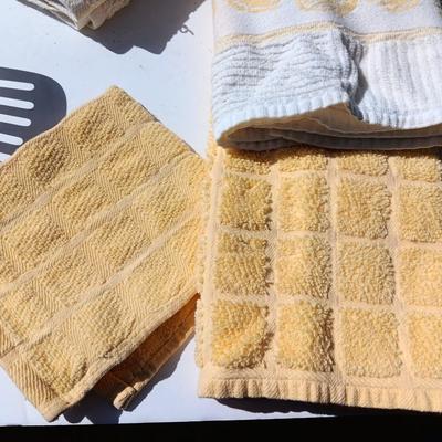 Stainless metal kitchen utensils with dish towels