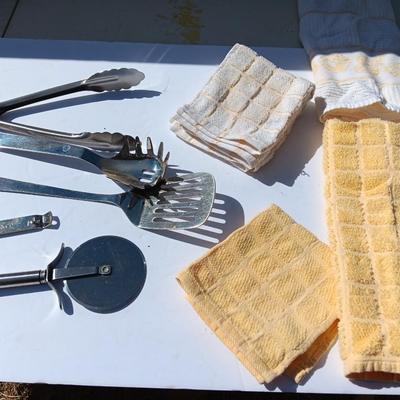 Stainless metal kitchen utensils with dish towels