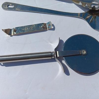 Stainless metal kitchen utensils with dish towels