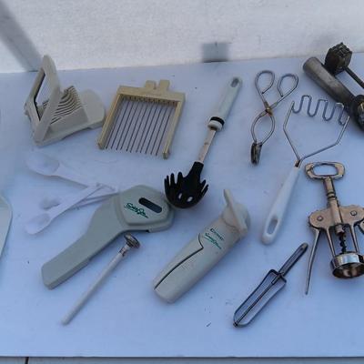 Assortment of mostly white handed Kitchen utensils -