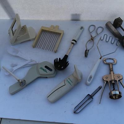 Assortment of mostly white handed Kitchen utensils -