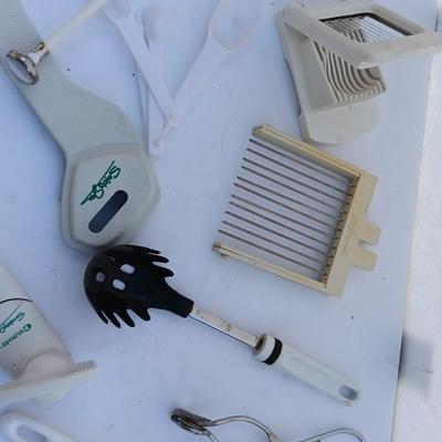 Assortment of mostly white handed Kitchen utensils -