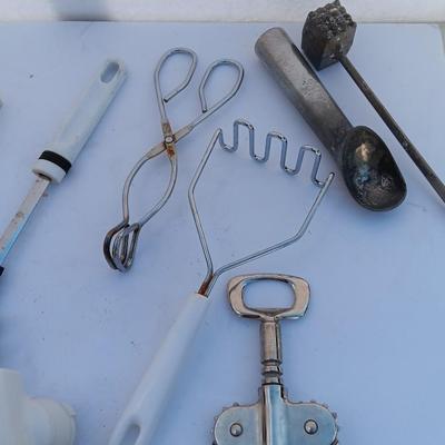 Assortment of mostly white handed Kitchen utensils -