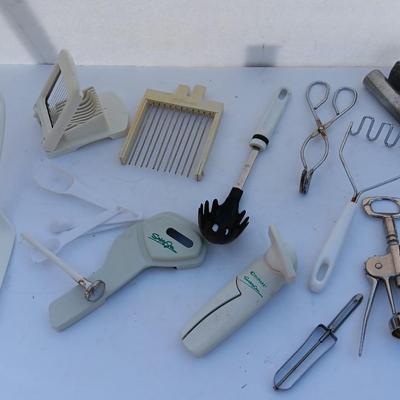 Assortment of mostly white handed Kitchen utensils -