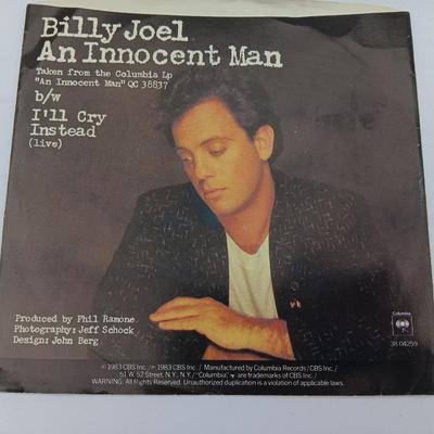 Two 45 LP Records - Billy Joel and Foreigner with original sleeves