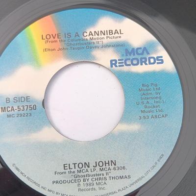 Four 45 LP Records -The rolling stones - The Doobie Brothers - The Beatles - and Elton John