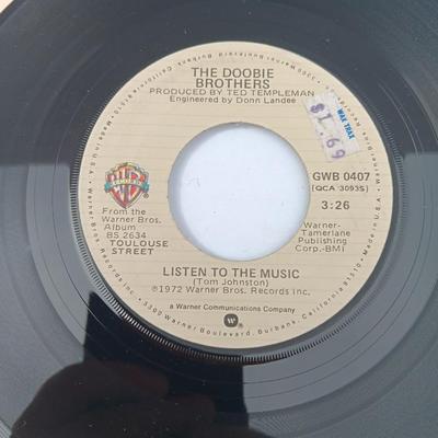Four 45 LP Records -The rolling stones - The Doobie Brothers - The Beatles - and Elton John
