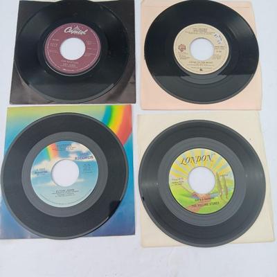 Four 45 LP Records -The rolling stones - The Doobie Brothers - The Beatles - and Elton John
