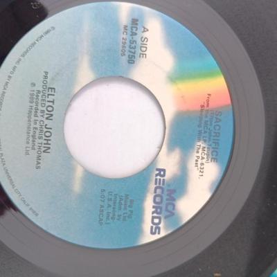 Four 45 LP Records -The rolling stones - The Doobie Brothers - The Beatles - and Elton John