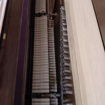 BALDWIN ACROSONIC PIANO ON CASTERS W/BENCH AND SHEET MUSIC