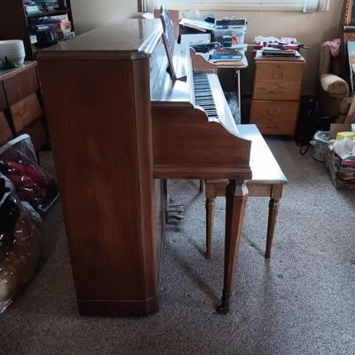 BALDWIN ACROSONIC PIANO ON CASTERS W/BENCH AND SHEET MUSIC
