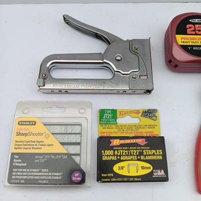 Variety of hand Tools - Stapler with staples - pliers - and 25-foot tape measure