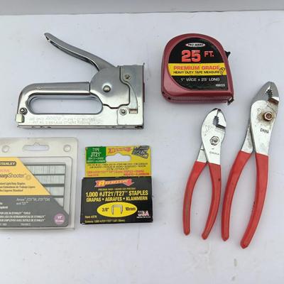 Variety of hand Tools - Stapler with staples - pliers - and 25-foot tape measure