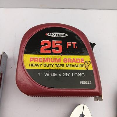 Variety of hand Tools - Stapler with staples - pliers - and 25-foot tape measure