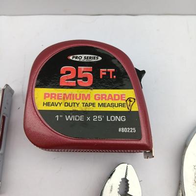 Variety of hand Tools - Stapler with staples - pliers - and 25-foot tape measure