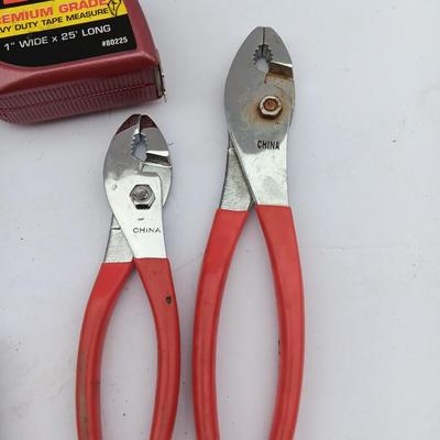 Variety of hand Tools - Stapler with staples - pliers - and 25-foot tape measure