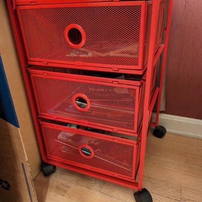 Red metal cart with drawers on wheels
