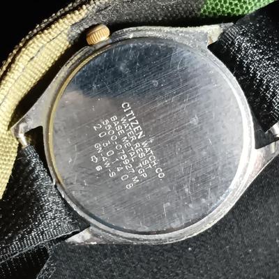 Military canteen with Military issued bags / pouches and a Citizen Quartz watch with a camo band