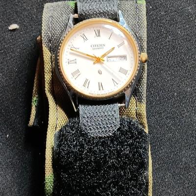 Military canteen with Military issued bags / pouches and a Citizen Quartz watch with a camo band