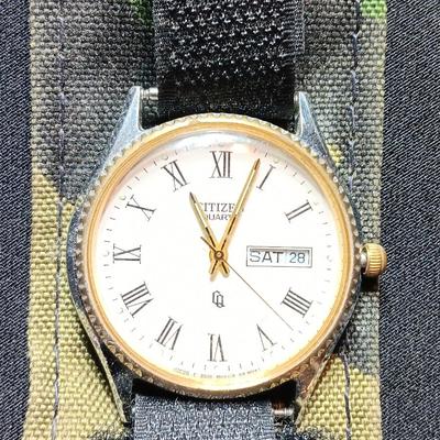 Military canteen with Military issued bags / pouches and a Citizen Quartz watch with a camo band