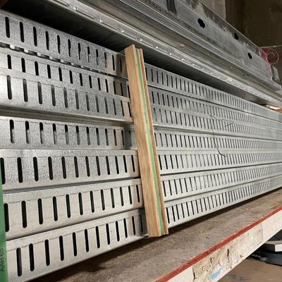 3 pcs. galvanized steel siding about 16' l pieces & stack of 2" x 4" and 2" x 6" galvanized steel studs...