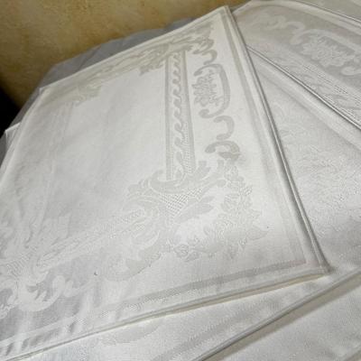 White brocade place mats