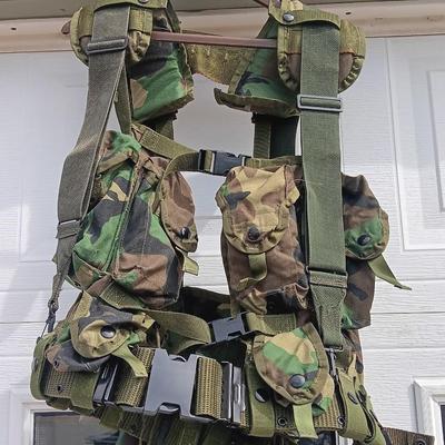 Military issued tactical load bearing vest with accessories.
