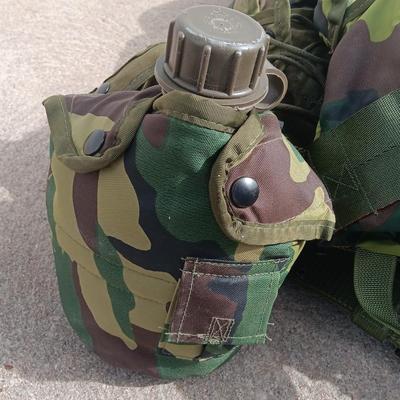 Military issued tactical load bearing vest with accessories.