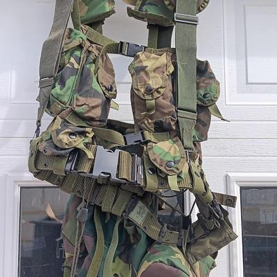 Military issued tactical load bearing vest with accessories.