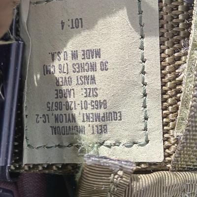 Military issued tactical load bearing vest with accessories.