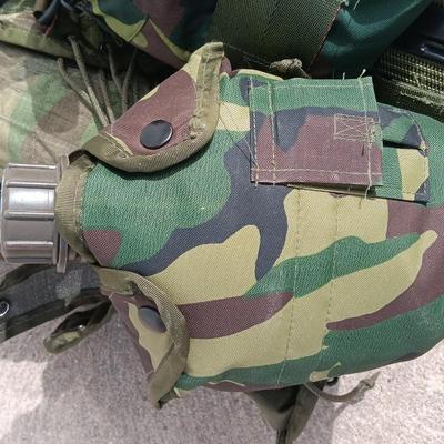 Military issued tactical load bearing vest with accessories.