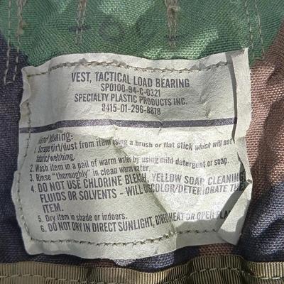 Military issued tactical load bearing vest with accessories.