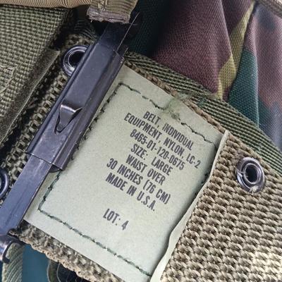Military issued tactical load bearing vest with accessories.