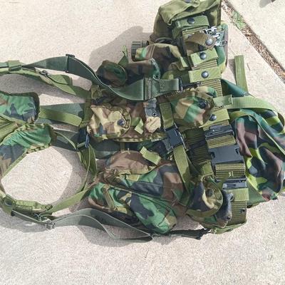Military issued tactical load bearing vest with accessories.