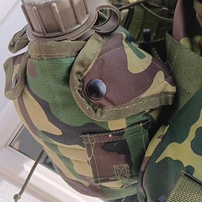 Military issued tactical load bearing vest with accessories.