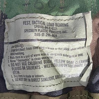 Military issued tactical load bearing vest with accessories.