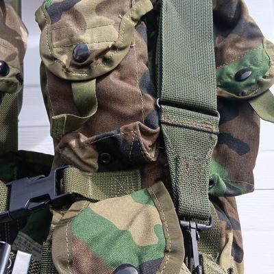 Military issued tactical load bearing vest with accessories.
