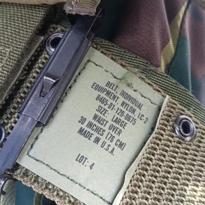 Military issued tactical load bearing vest with accessories.