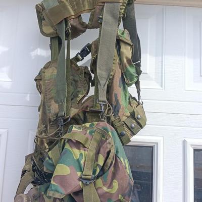 Military issued tactical load bearing vest with accessories.
