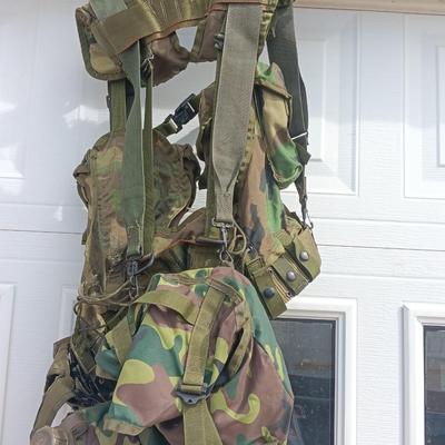 Military issued tactical load bearing vest with accessories.