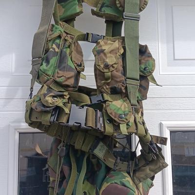 Military issued tactical load bearing vest with accessories.