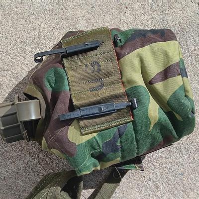 Vector pack systems camo canvas bag with camouflage hat and pouch and canteen.
